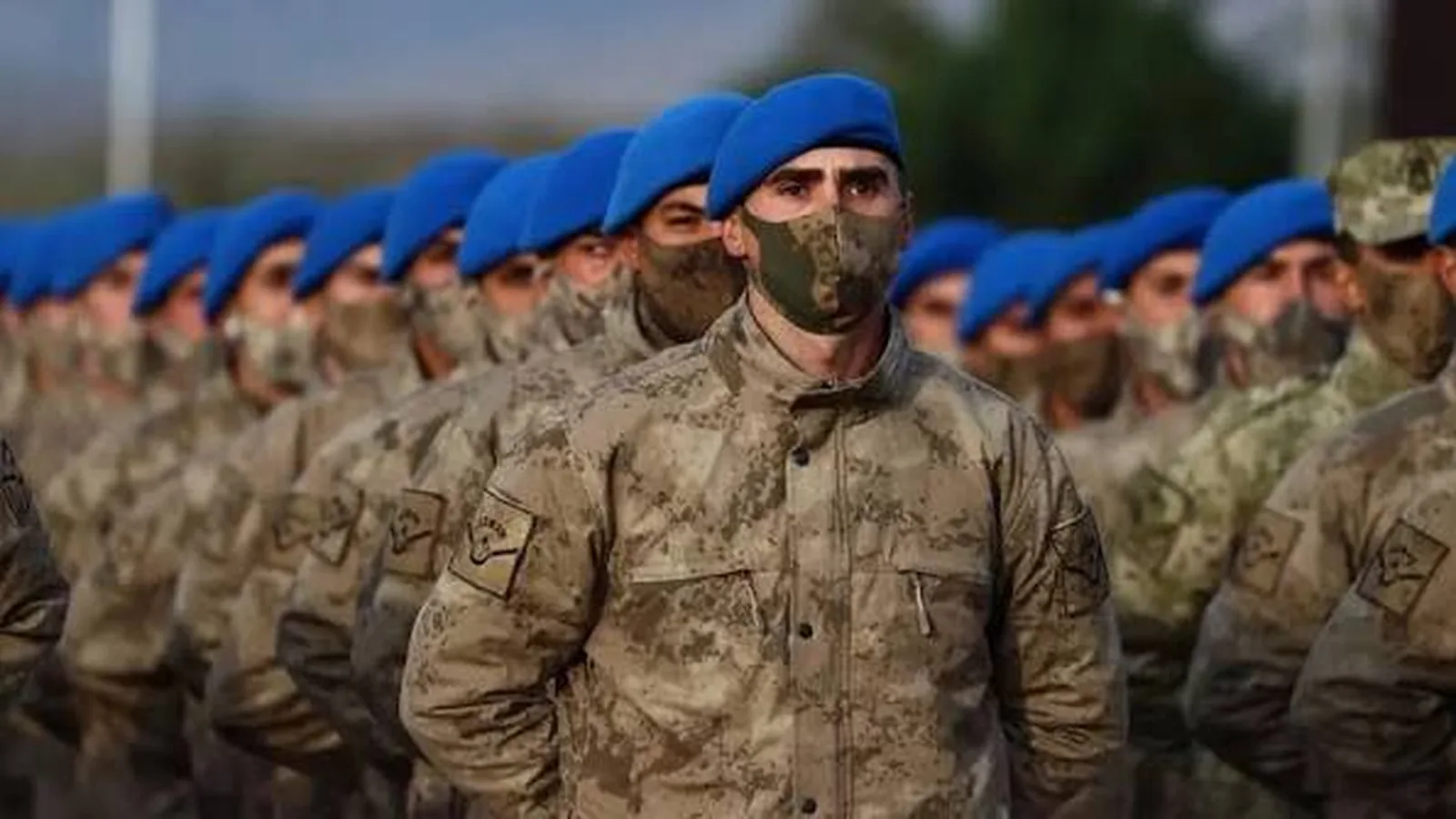 Tören düzeninde sıralanmış, mavi bereli askerler